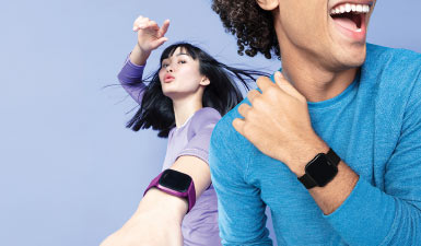 Young couple wearing Fitbit smartwatches