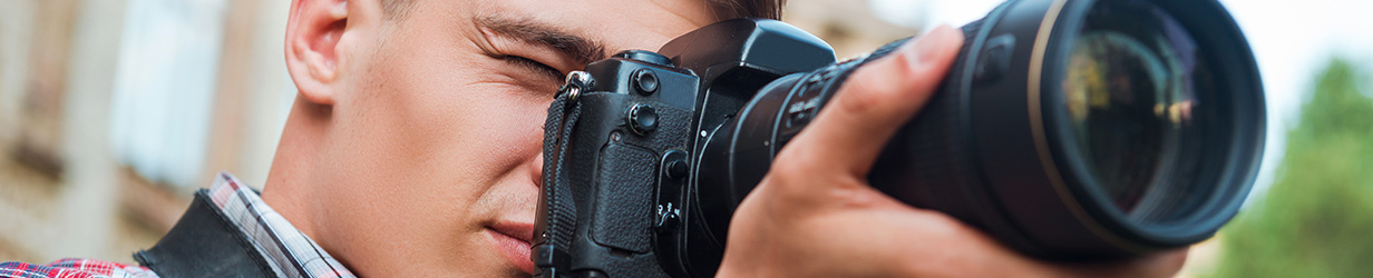Close up of man taking a picture with a DSLR camera